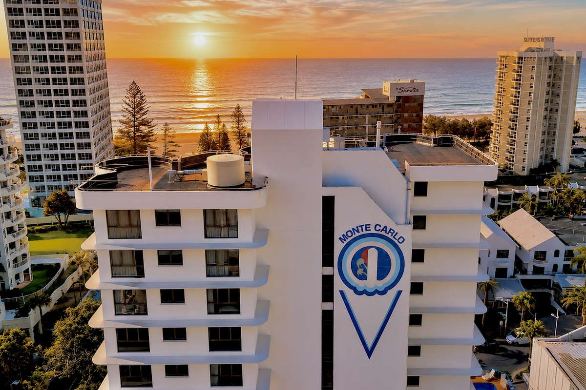 The high-rise outlook adds beach, ocean and skyline views to the apartment, connecting the balcony and living spaces with the coast beyond.