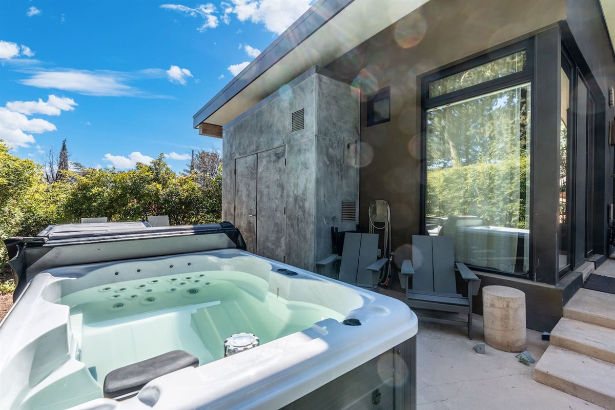 Private outdoor hot tub beside the home, with modern finishes and cozy seating for relaxing soaks.