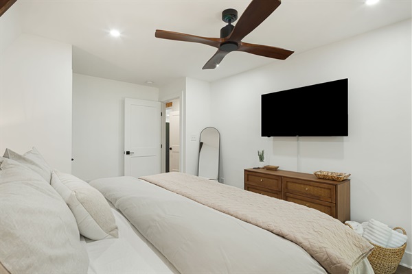 This bedroom on the 1st floor has a comfortable king size bed, nightstands, dresser and a full body mirror. Also available is a closet with hangers and shelves for storing personal items. A smart TV, extra blankets & luggage rack  is also available.