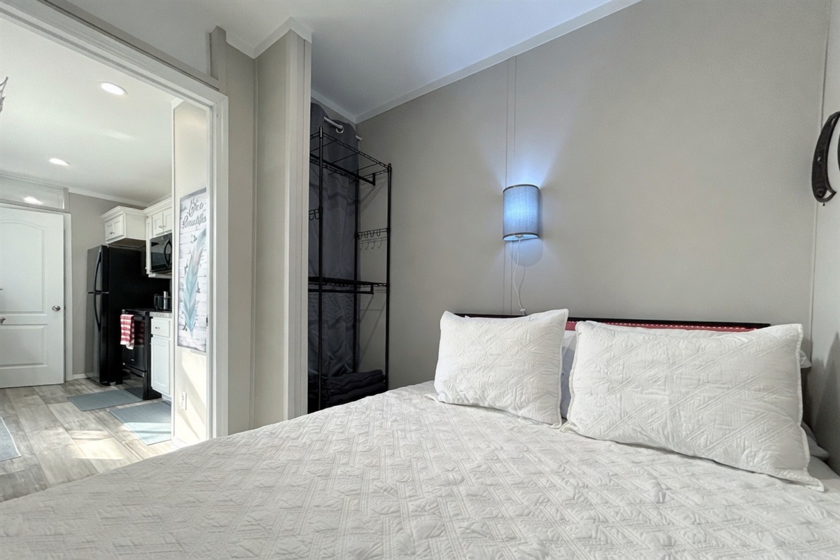 Bedroom #1 with queen bed, smart TV, en-suite bathroom & hidden washer/dryer combo
