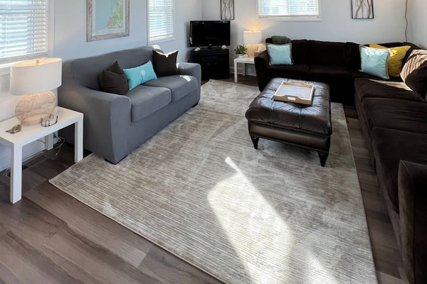 Cozy Living room equipped with ample seating and a large Smart TV.