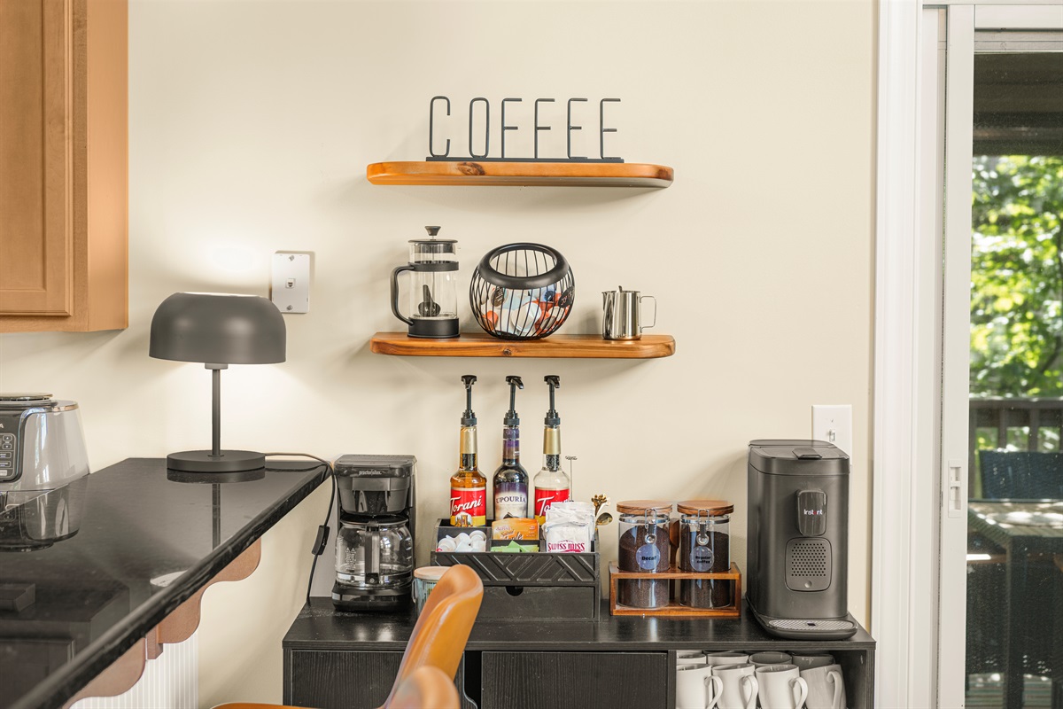 Stylish, well-stocked coffee bar with K-pod, Nespresso, drip, and French press — plus teas, syrups, and sweet sips for every guest