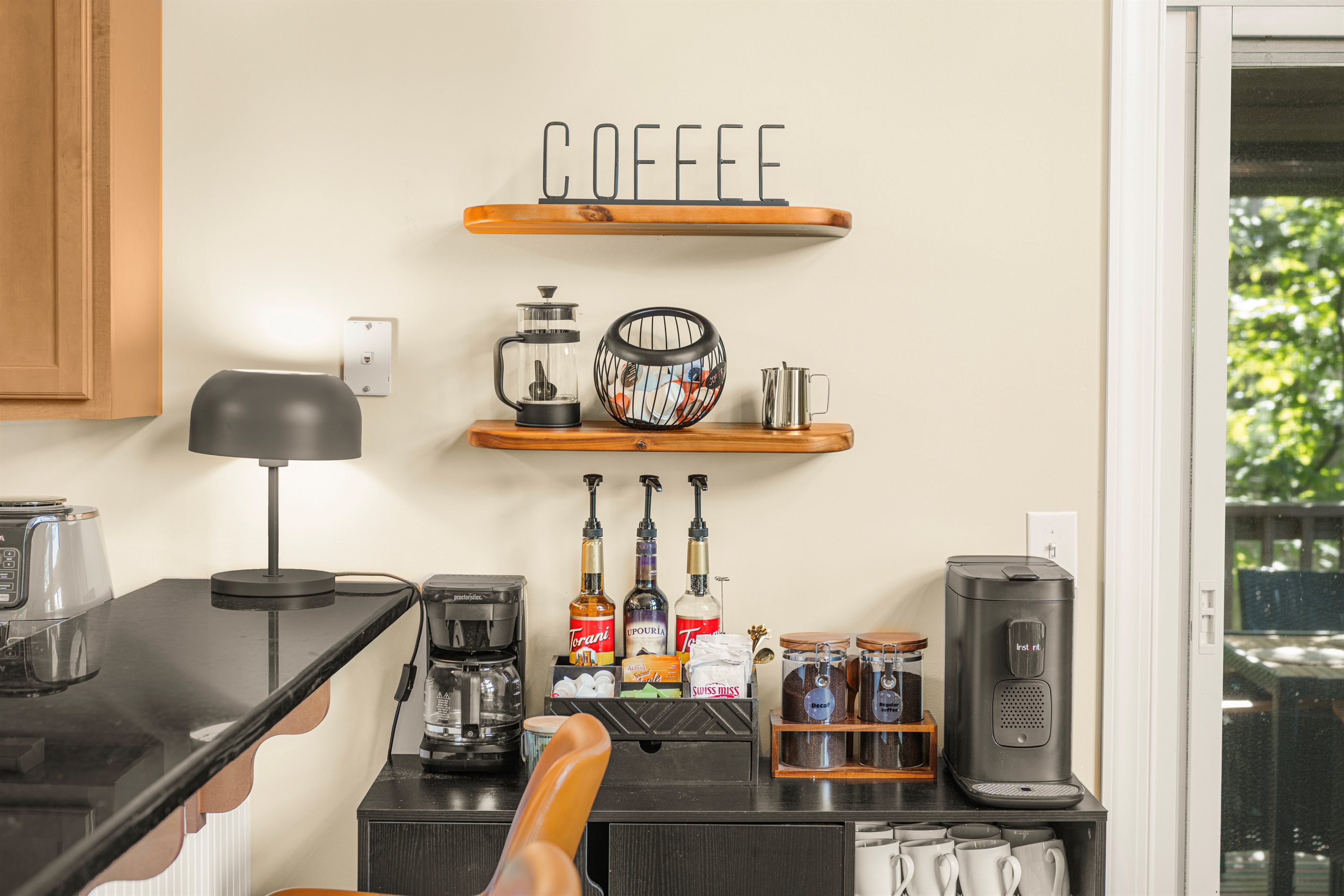 Stylish, well-stocked coffee bar with K-pod, Nespresso, drip, and French press — plus teas, syrups, and sweet sips for every guest