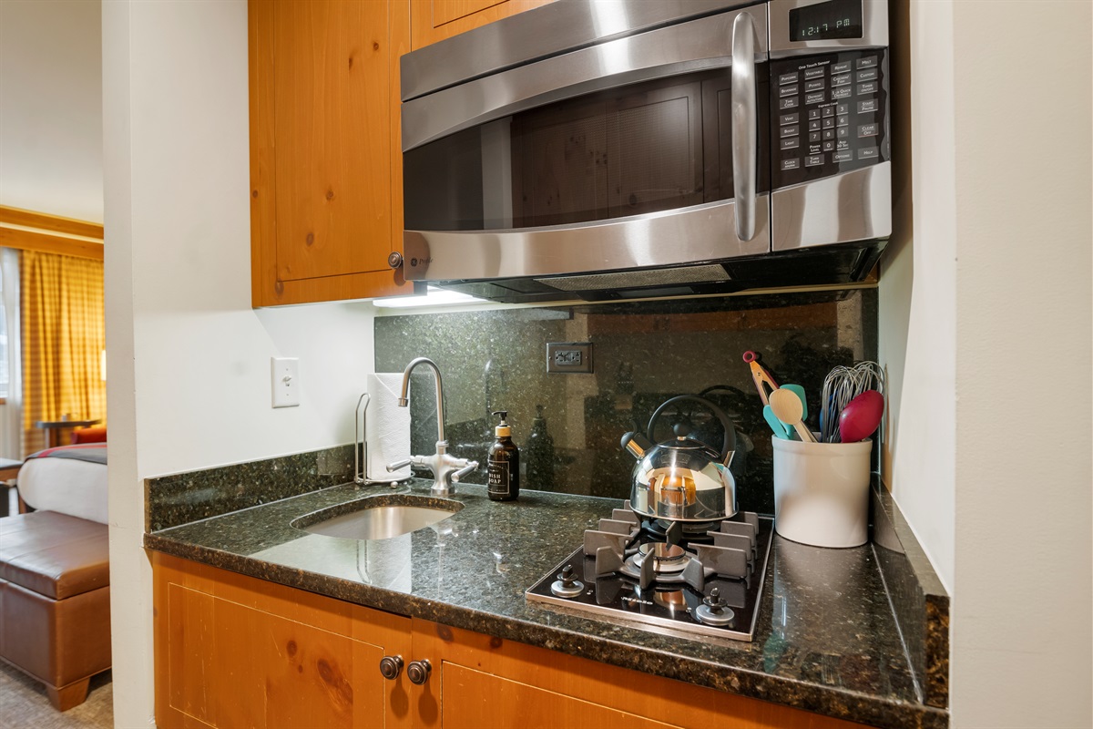 The kitchenette is equipped with a stove-top, microwave, dishwasher and refrigerator for your convenience