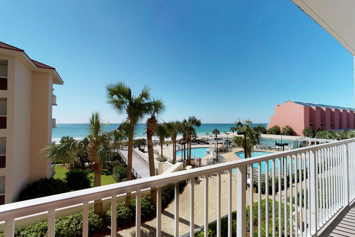 Private balcony overlooking the pools, beach, and Gulf.