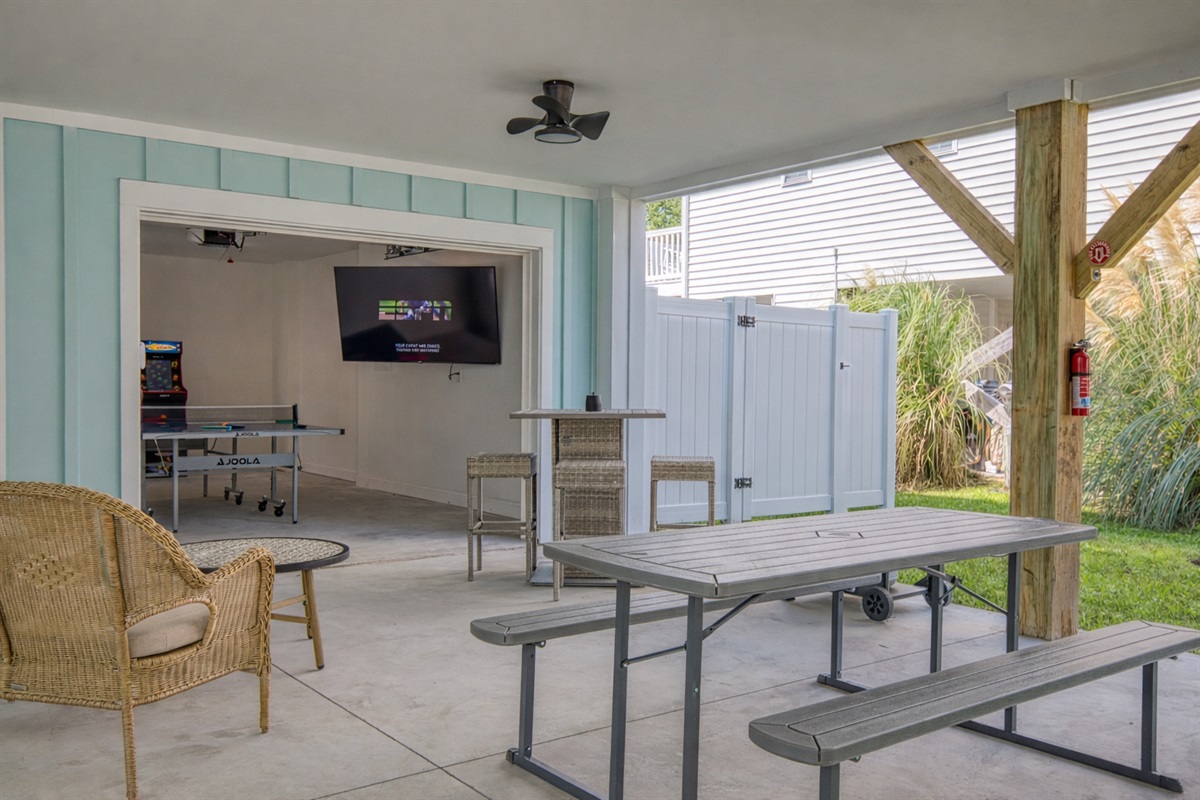 Lower Entertainment Area with Seating, Tv, Ping Pong, and arcade