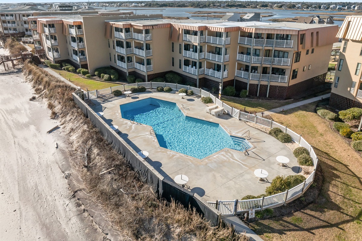 Enjoy the oceanfront pool just steps from the sand, offering a refreshing place to swim while taking in the coastal views at Topsail Dunes