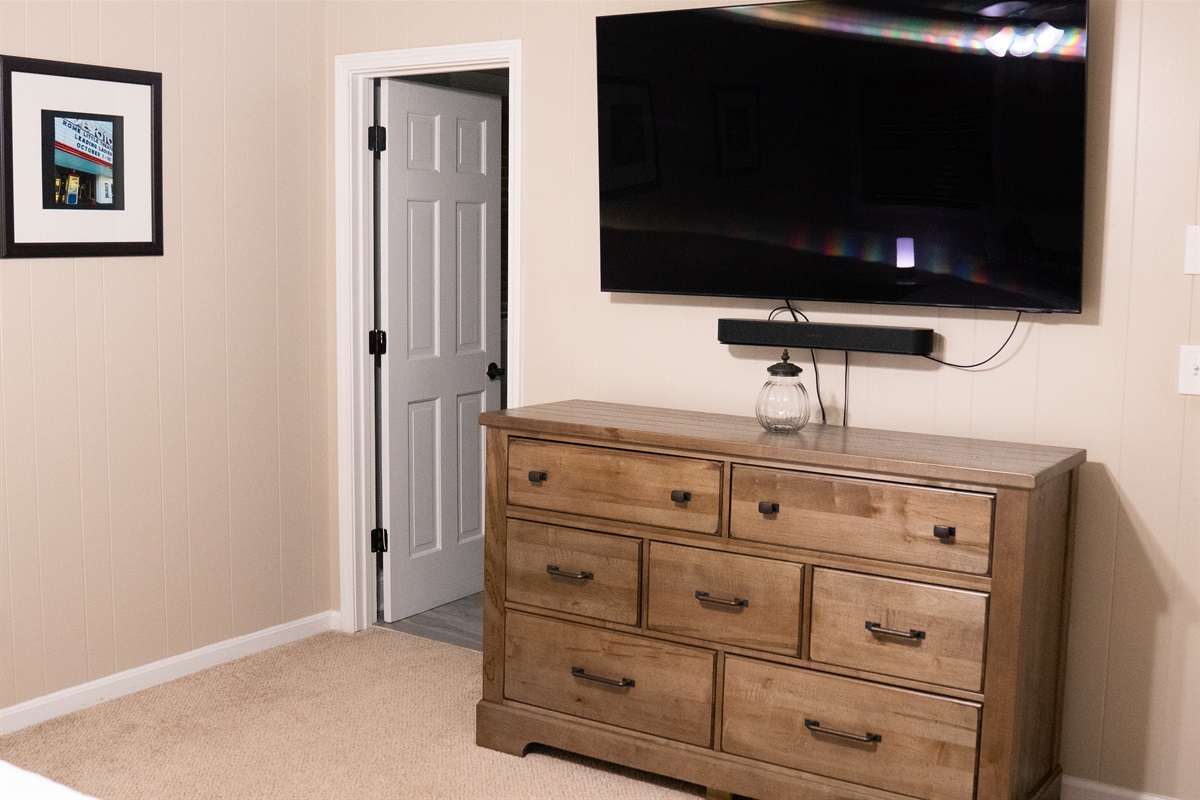 The king suite features a smart TV mounted on the wall for comfortable entertainment.