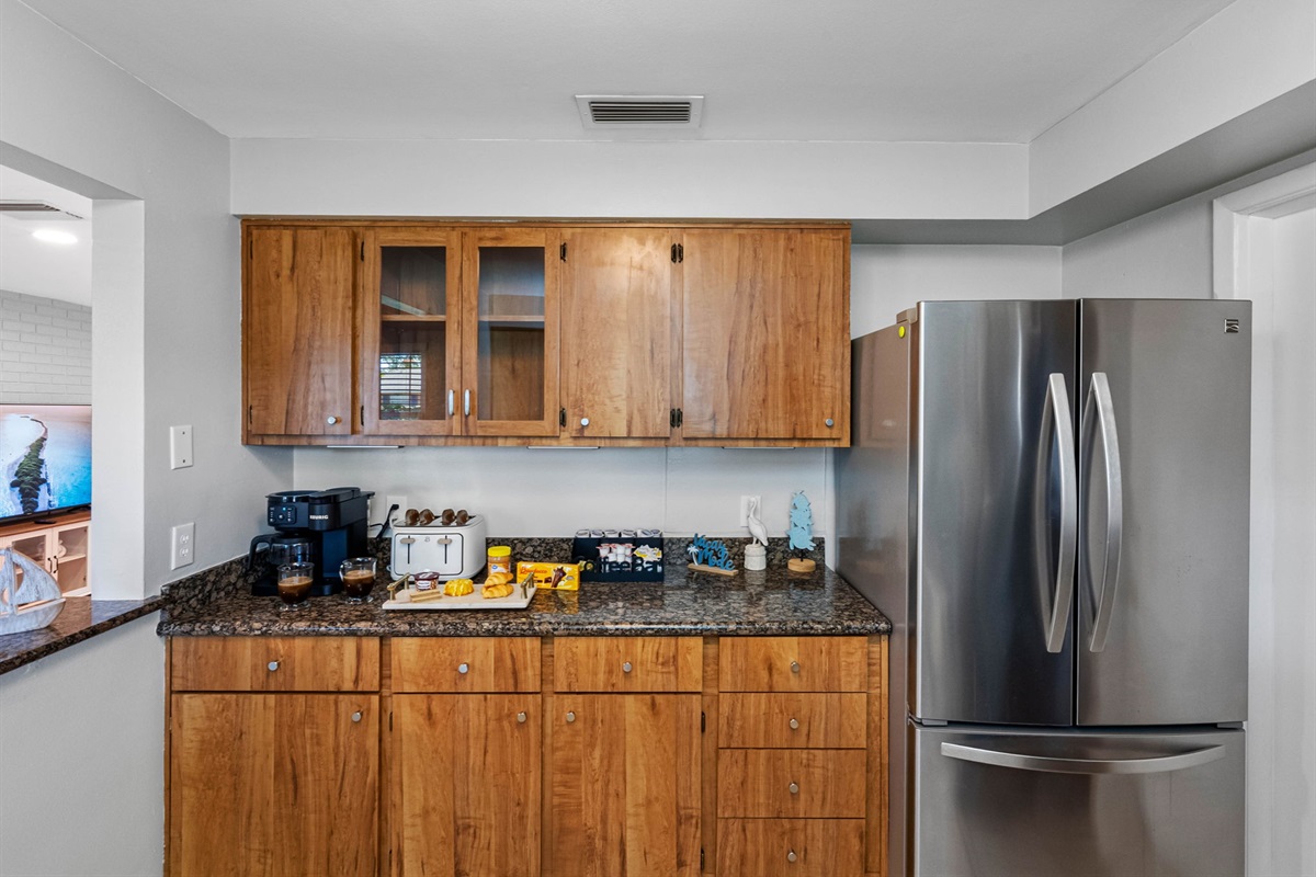 Warm wood cabinetry meets modern convenience in this stylish and functional kitchen.