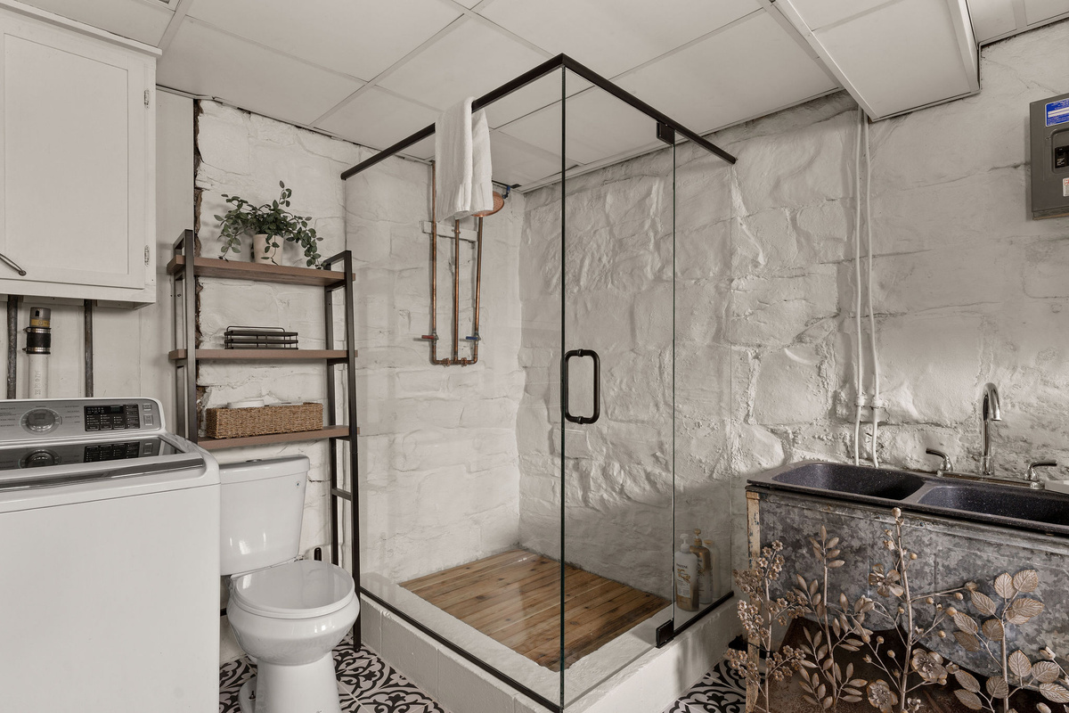 This gorgeous new glass-enclosed shower gave our lower-level bathroom a serious upgrade.