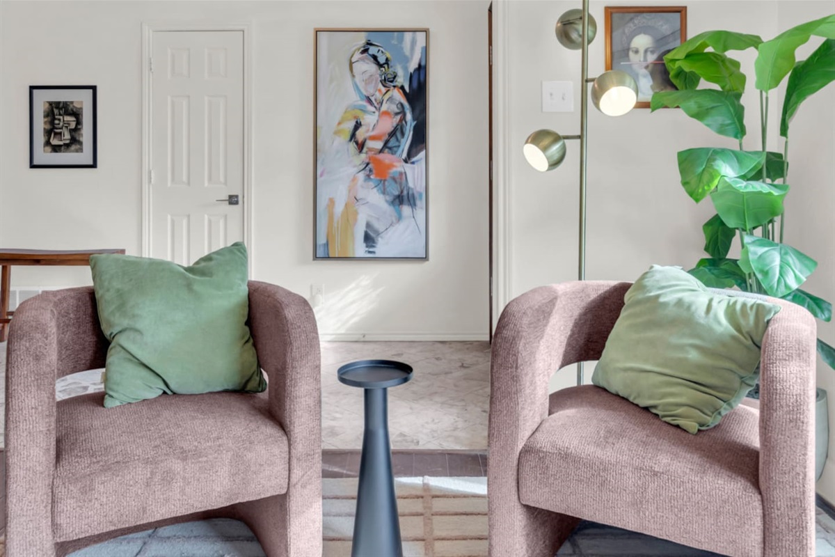 Sitting area with two comfortable chairs, offering a cozy spot for conversation, reading, or relaxing in a quiet corner of the home.