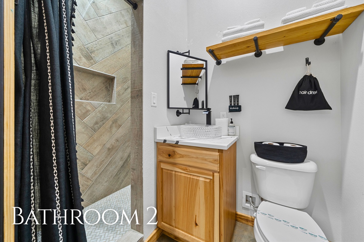 Bathroom 2 features a clean, modern vanity and a roomy shower, giving guests a comfortable space to get ready each day.