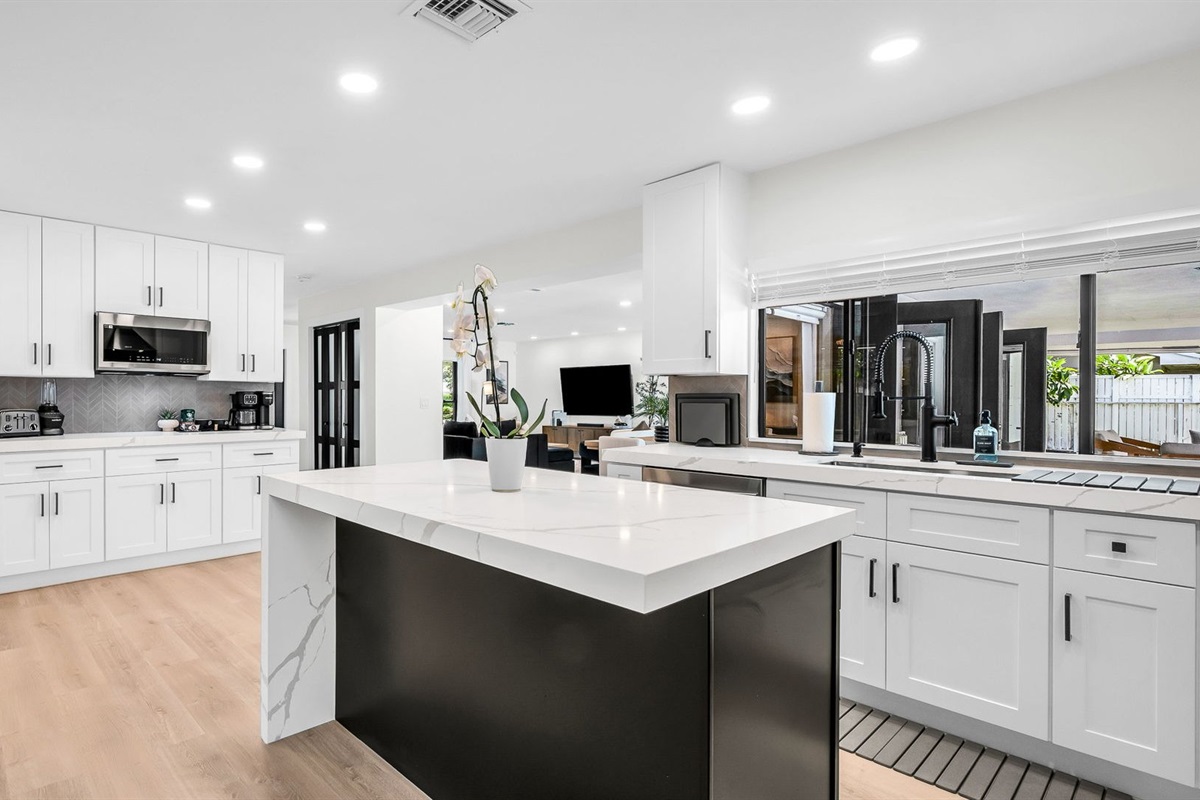 Bright and airy, this modern kitchen combines luxury finishes with everyday comfort. Enjoy the designer backsplash, expansive counter space, and seamless flow to the dining and living areas.