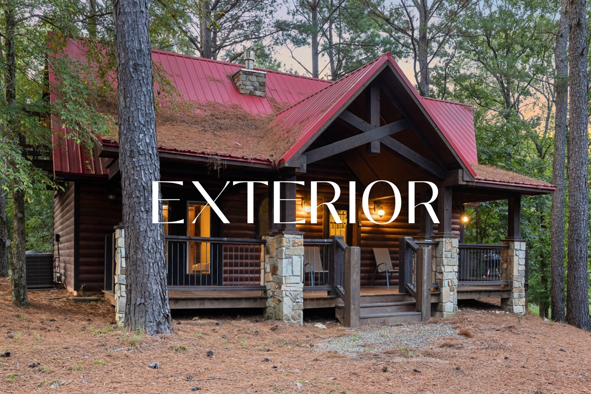 Charming exterior with a red roof and classic cabin vibes.