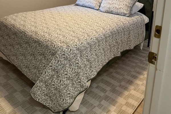 Spacious primary bedroom featuring a comfortable king bed, soft linens, and a relaxing atmosphere for a great night’s sleep.