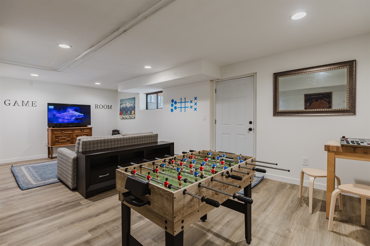 Game room includes board games, a pull-out couch, vintage Atari, and karaoke for nights full of fun.