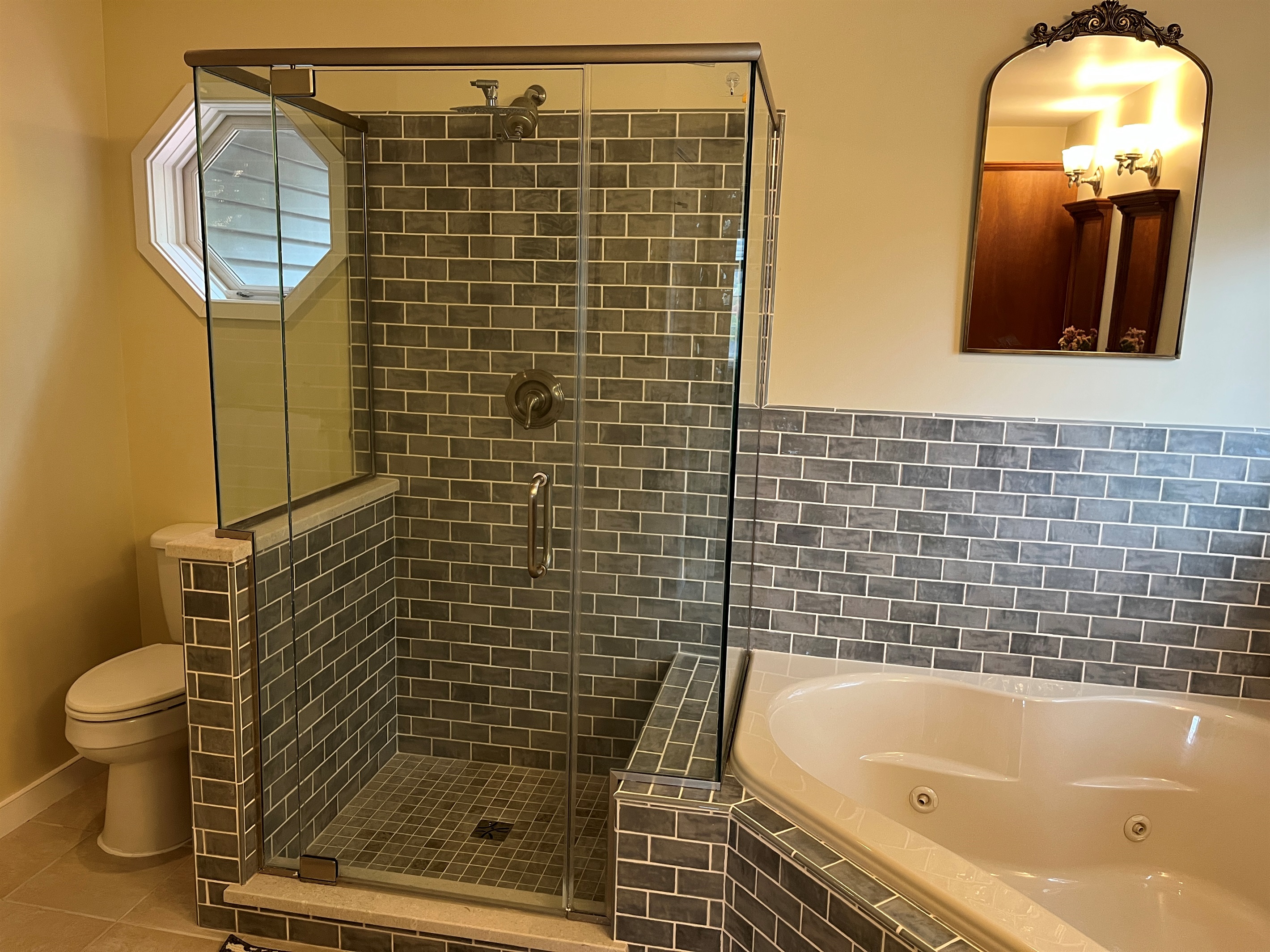 Primary bath with jetted tub and frameless glass shower