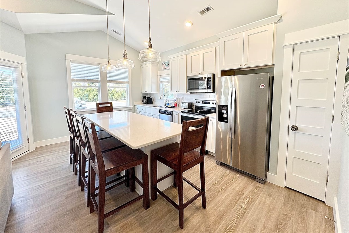 Spacious kitchen with island seating and stainless steel appliances