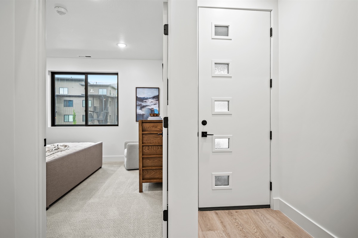 Entrance to the main floor and view of the main floor bedroom.