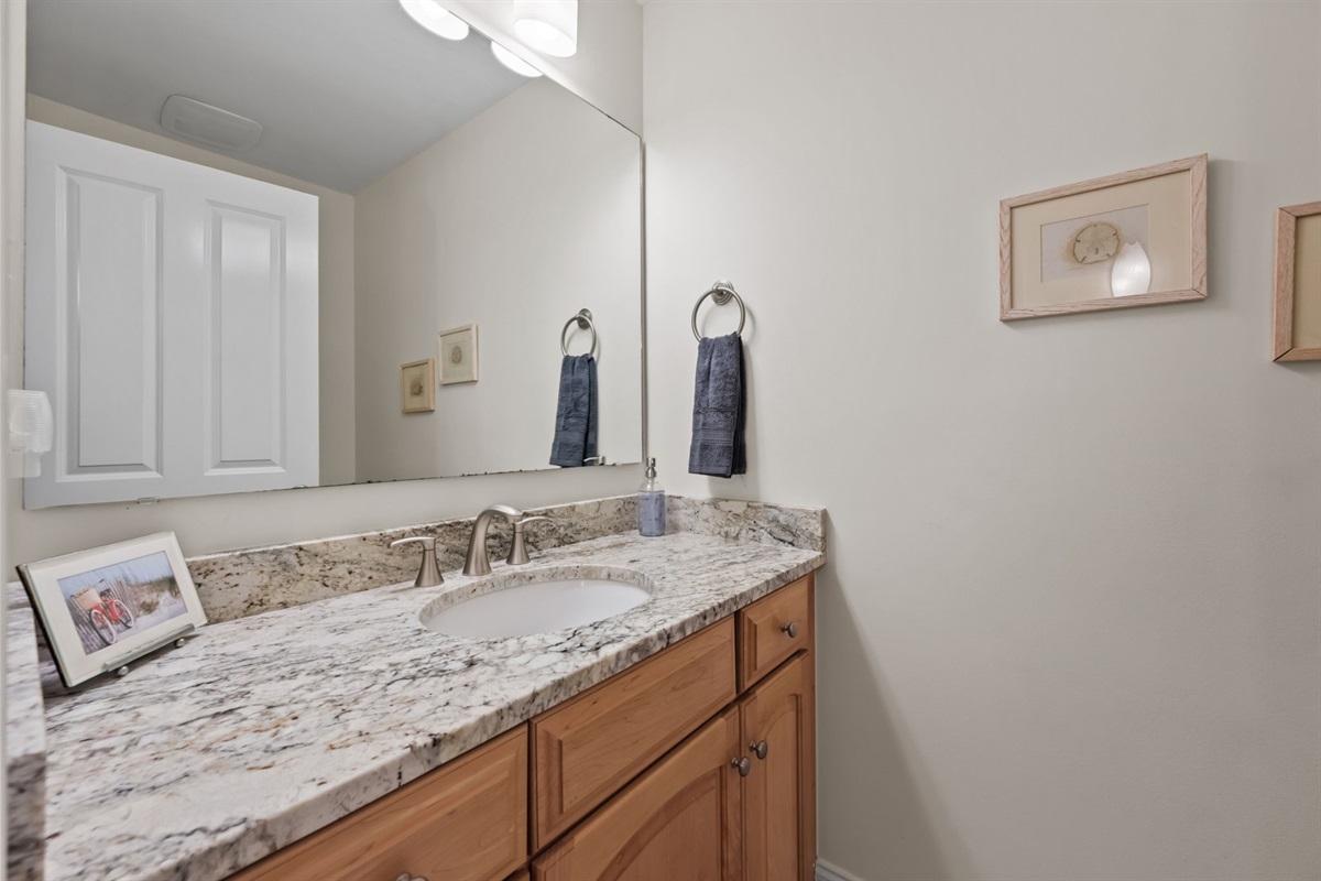 Granite vanity with modern fixtures and ample counter space