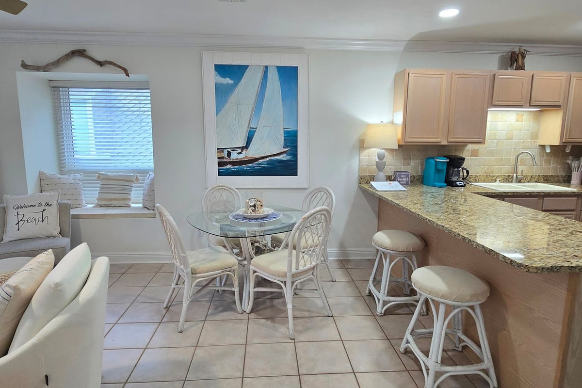 Seat everyone at once &mdash; dining table for four plus two more at the breakfast bar means nobody eats standing up on vacation.
