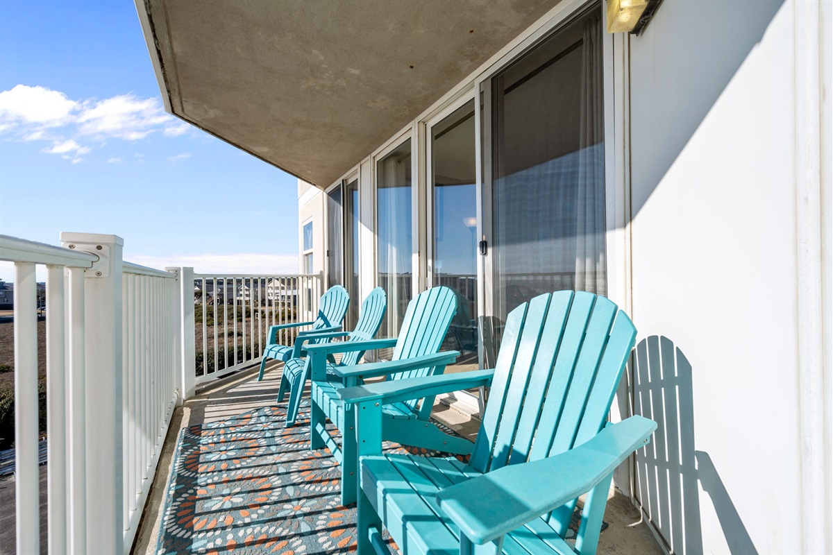 Private corner balcony with Adirondack seating&mdash;ideal for morning coffee and fresh ocean air