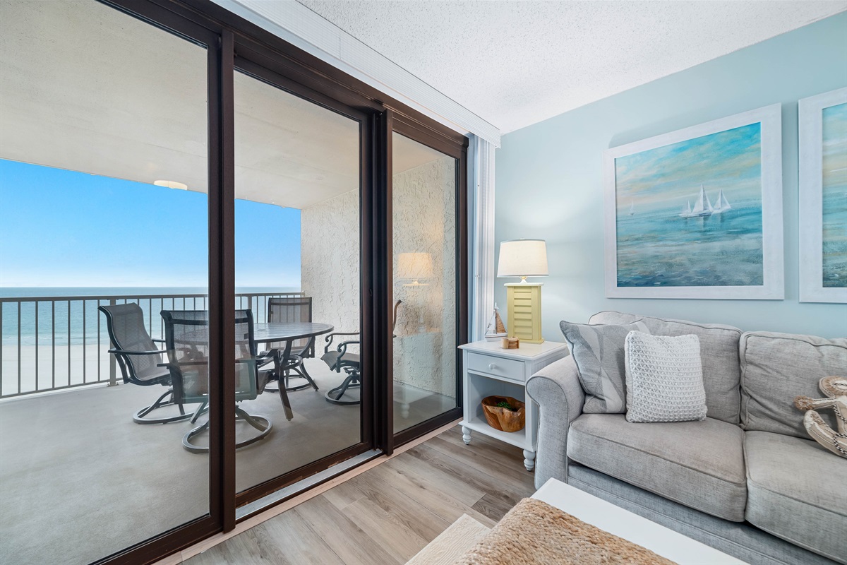 Experience the beauty of indoor-outdoor living with expansive sliding doors leading to a private balcony overlooking the ocean.