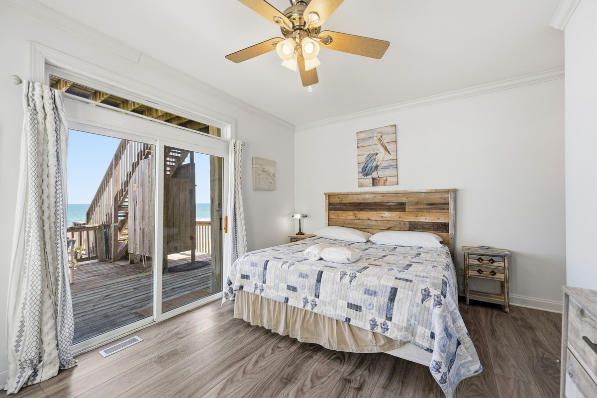 Private coastal bedroom retreat with balcony access and calming beachside design