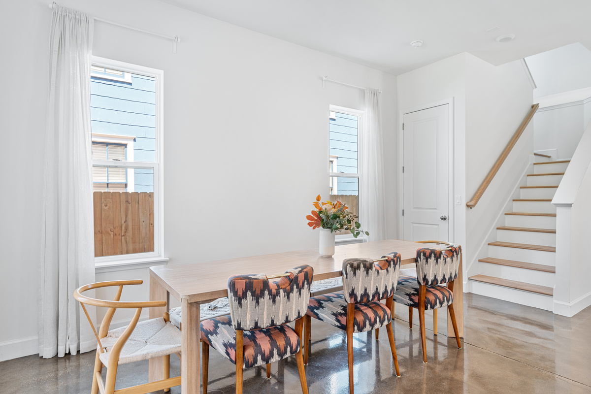 Pull up a chair and stay awhile. This long table is where the day gets told, second helpings and card games and someone laughing too loud. Sunlight pours in and nobody is in a hurry to clear the plates.