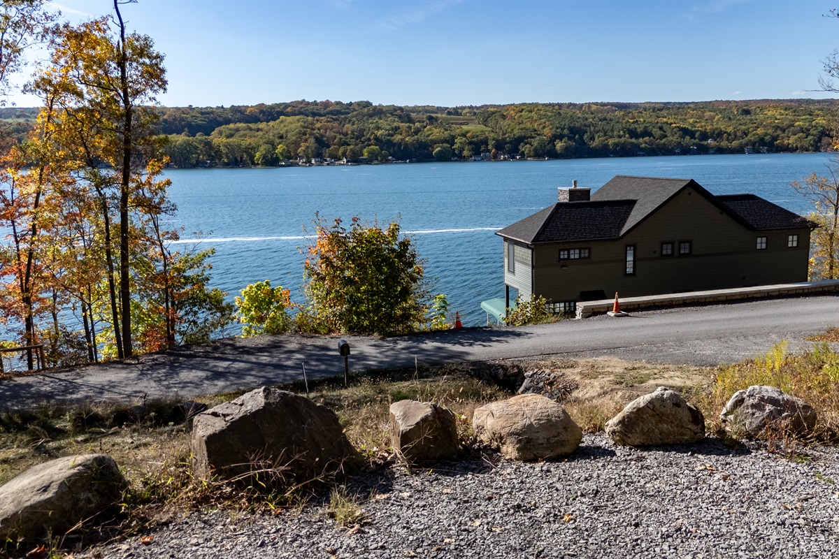 Clear lakeside view from cabin property — gentle waves meet the woods.