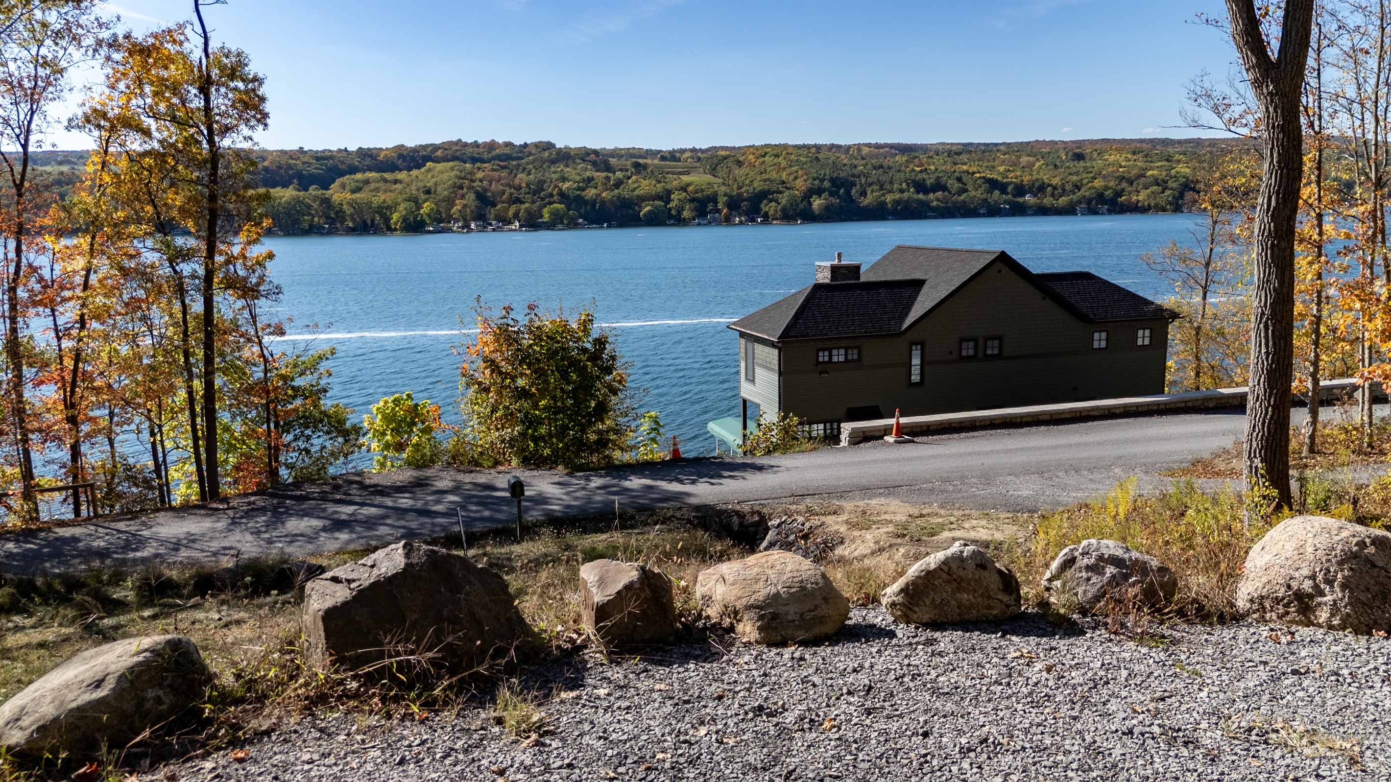 Clear lakeside view from cabin property — gentle waves meet the woods.