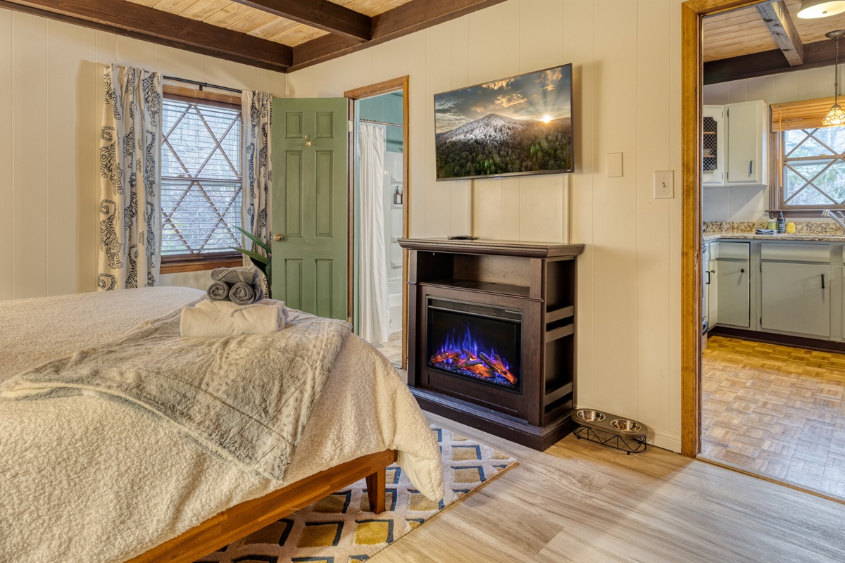 This room features an electric fireplace for added warmth and ambiance, and a flat-screen TV for your entertainment needs.