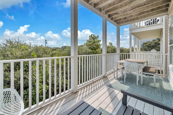 Dine al fresco on the second-floor balcony, which sits off the family room and overlooks 30A and the gulf