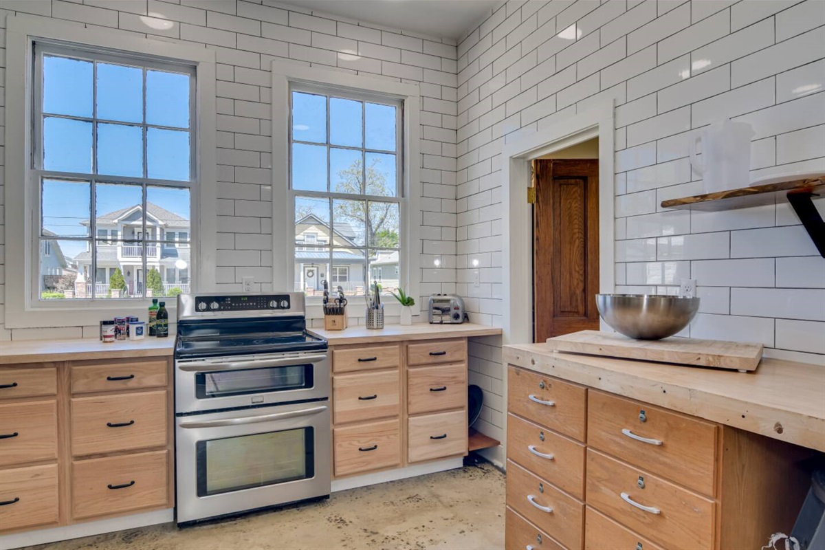 Kitchen with stainless steel appliances and farmhouse sink.