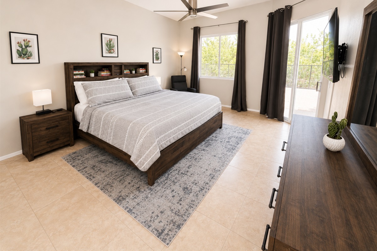 You'll sleep great in the spacious primary bedroom. King size bed, 2 nightstands, dresser and a recliner. Walk right out the sliding doors to the backyard and pool.
