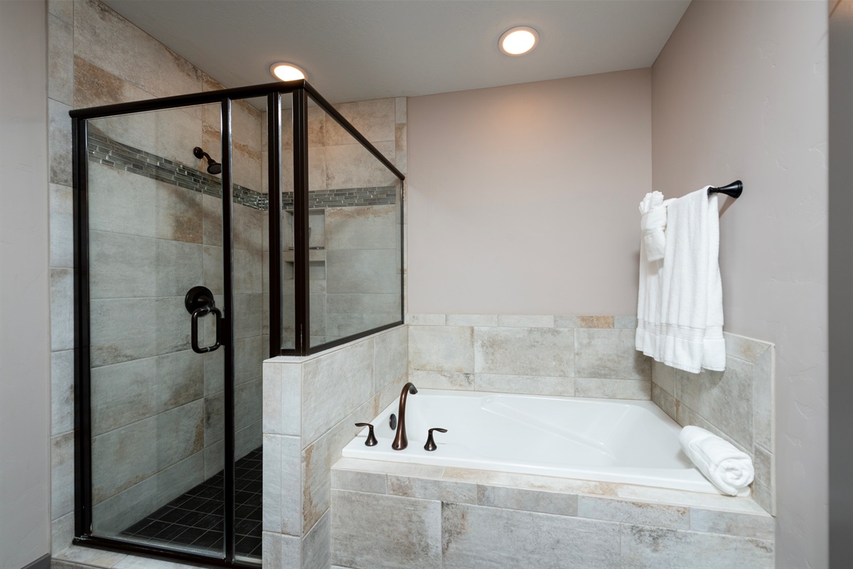 Elegant primary bath with soaking tub and separate shower.