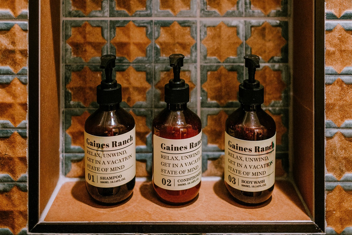 Curated Gaines Ranch on the Square bath amenities — body lotion, hand wash, and bath essentials in every suite, including Cutter's Quarters.