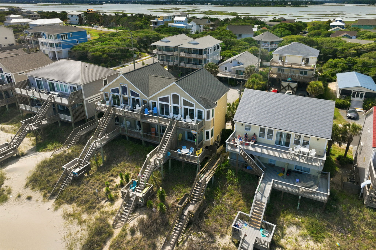 Private oceanfront deck with seating and dunes below