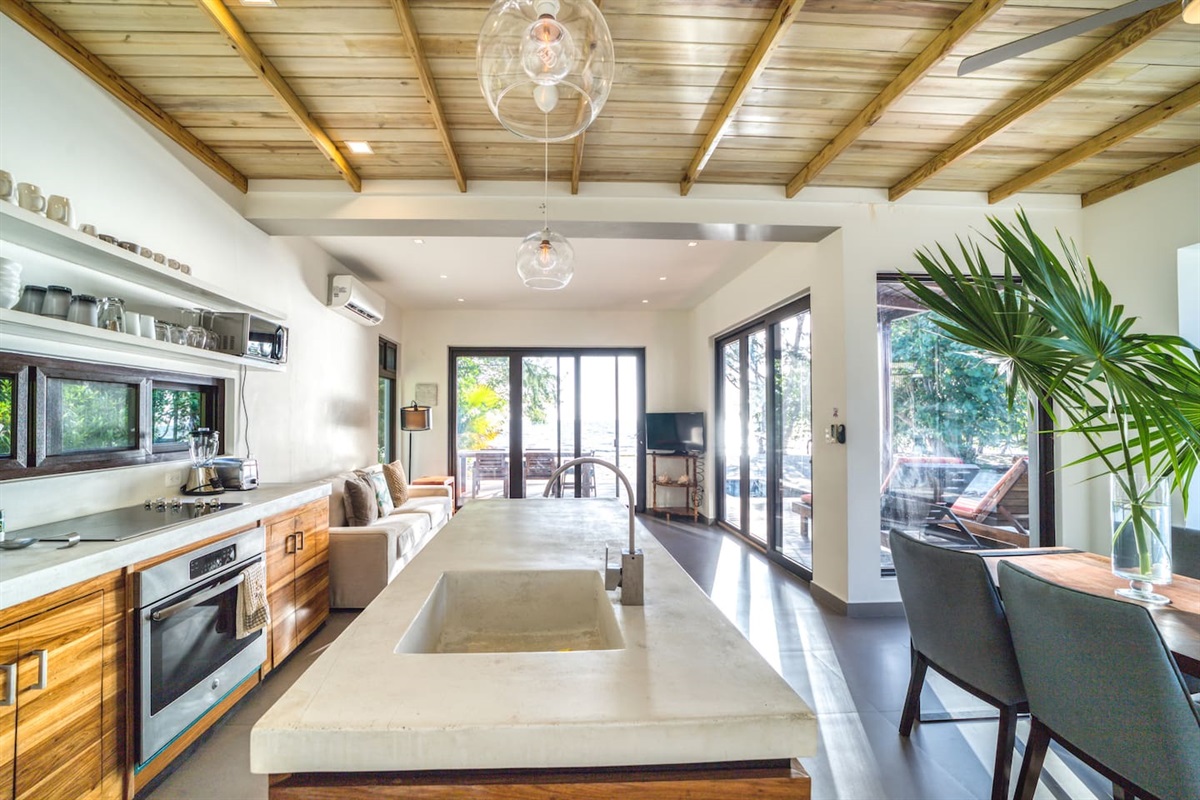 Fully equipped kitchen with cook top, oven, dishwasher, microwave, toaster, blender,  coffee machine, silverware, flatware, glassware