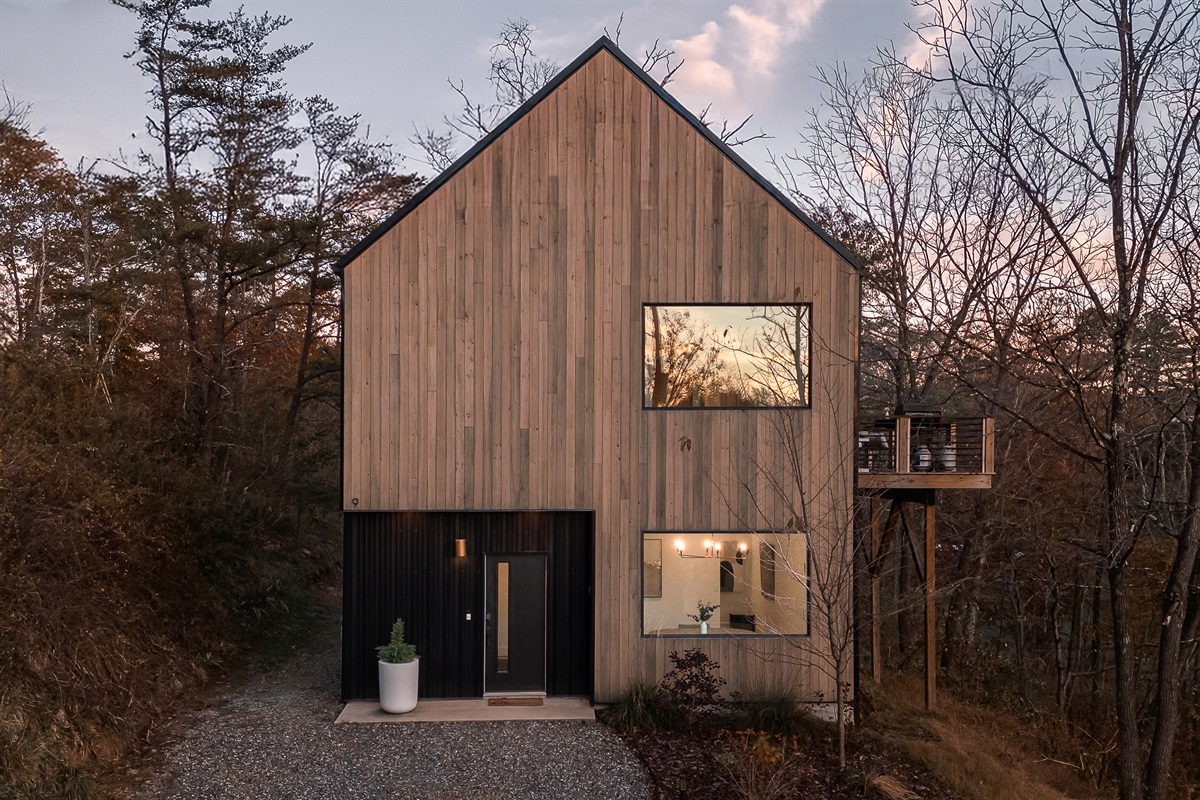 {Exterior – Gallery House} A modern silhouette wrapped in warm wood and sunset reflections—your elevated hideaway in the Blue Ridge.