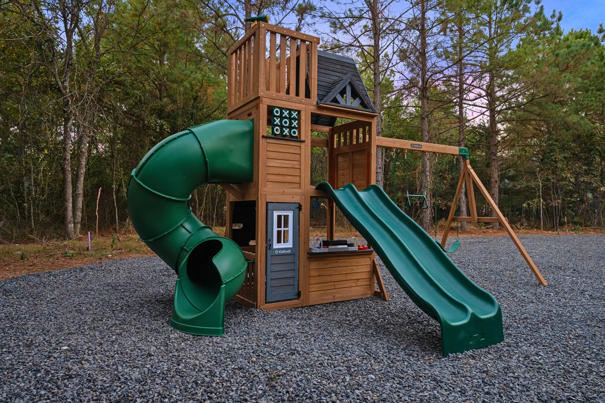 The kids’ playset adds excitement to outdoor time, giving little ones plenty to climb, slide, and explore.