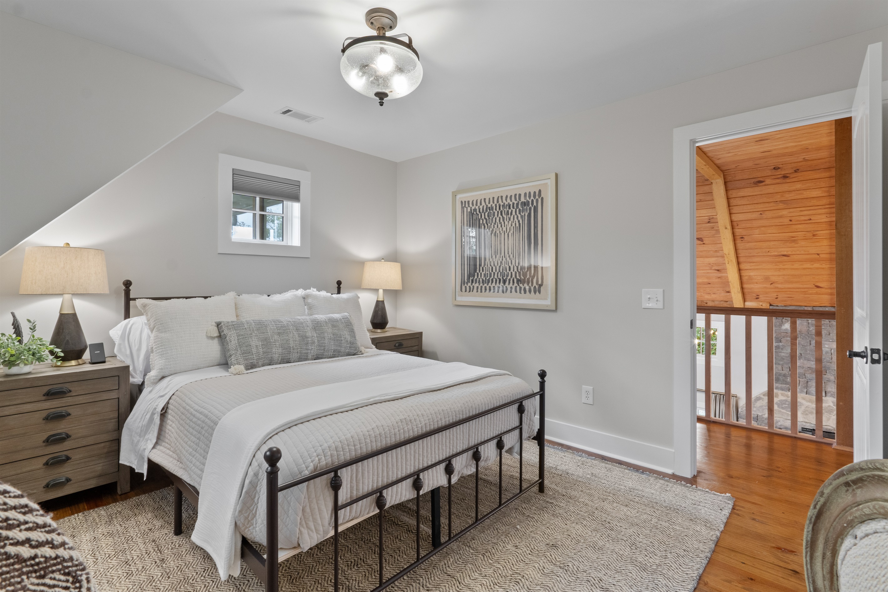 The fourth bedroom features premium bedding and updated décor, creating a cozy and stylish retreat for guests.