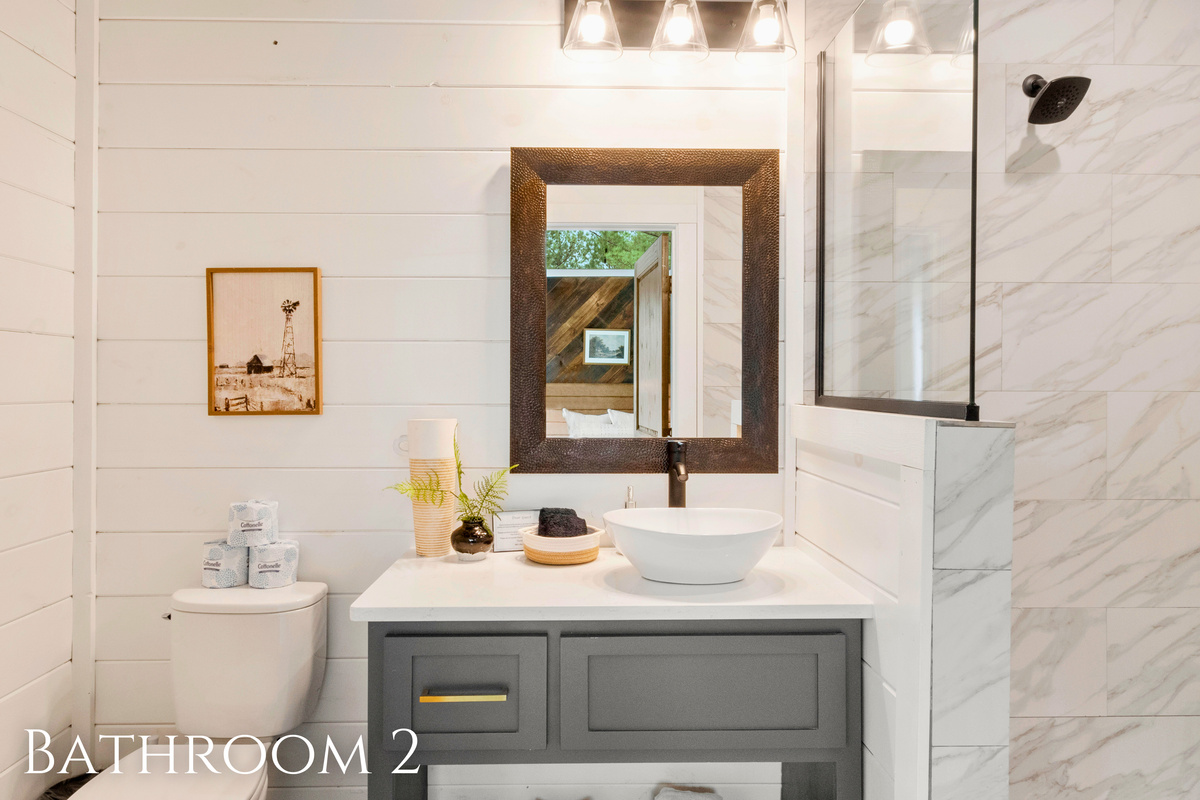 Freshen up in our modern bathroom, styled with sleek tile and thoughtful touches. It's your own spa escape right here in the woods!