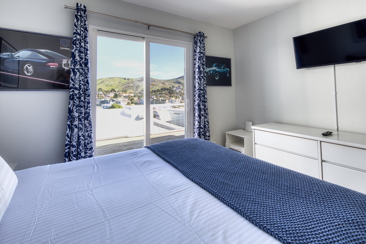 Curl up in this cozy bedroom with nature views and a big-screen TV for late-night unwinding.