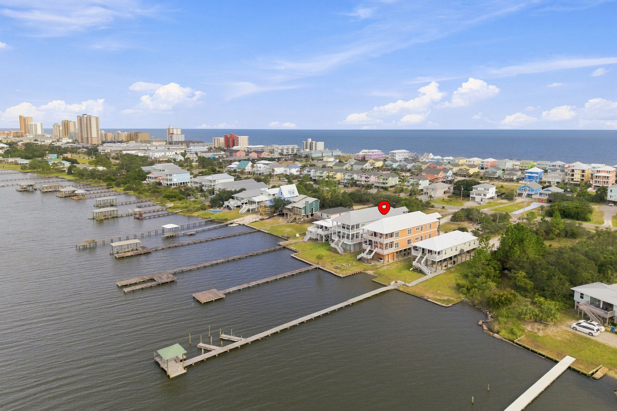 Aerial showing the lagoon, docks, and the Gulf beach just beyond