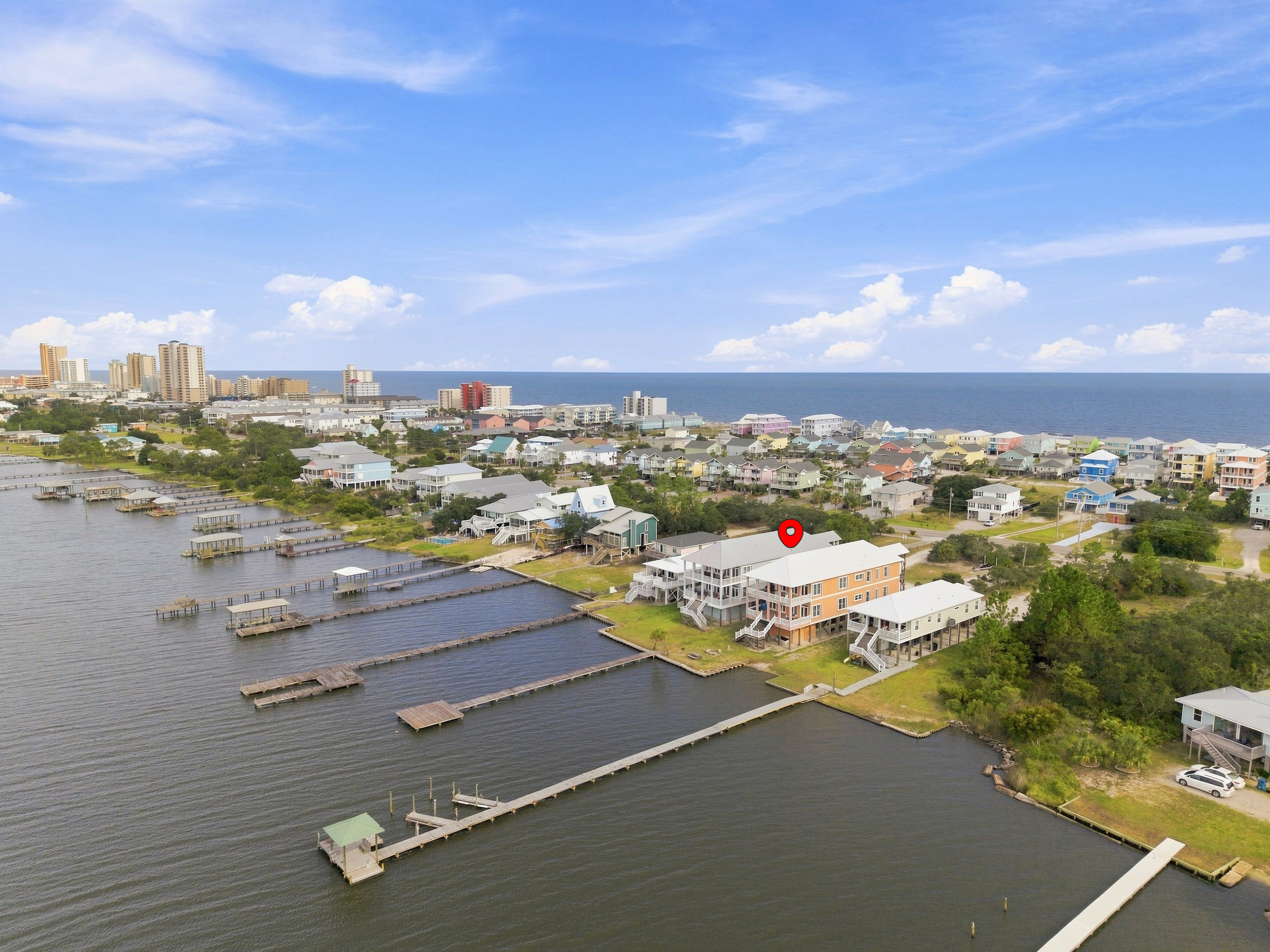 Aerial showing the lagoon, docks, and the Gulf beach just beyond