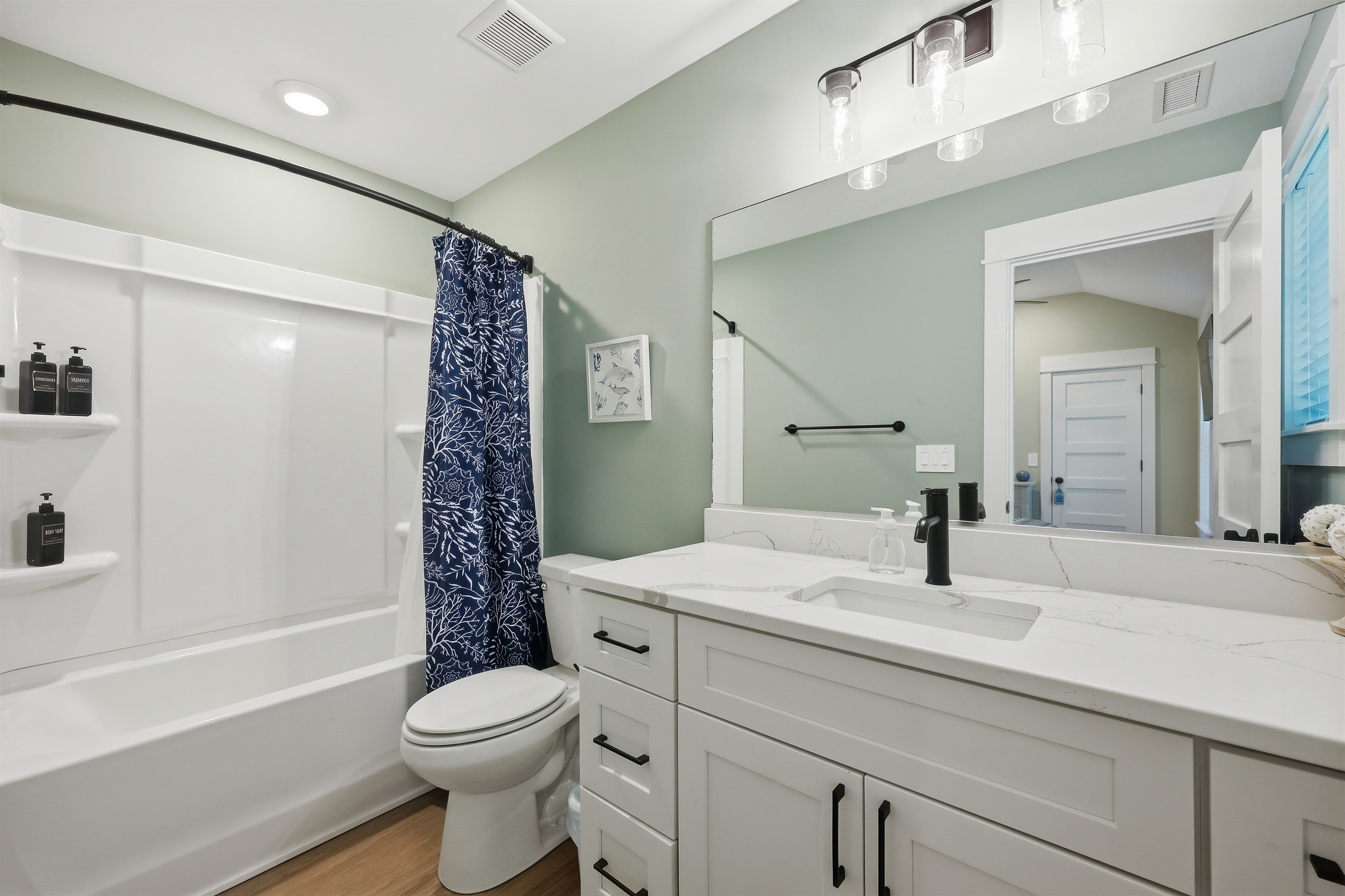 Private queen ensuite bathroom with tub/shower combo and large vanity