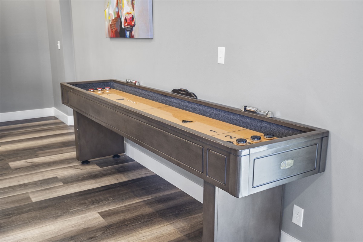 Lower level shuffleboard table