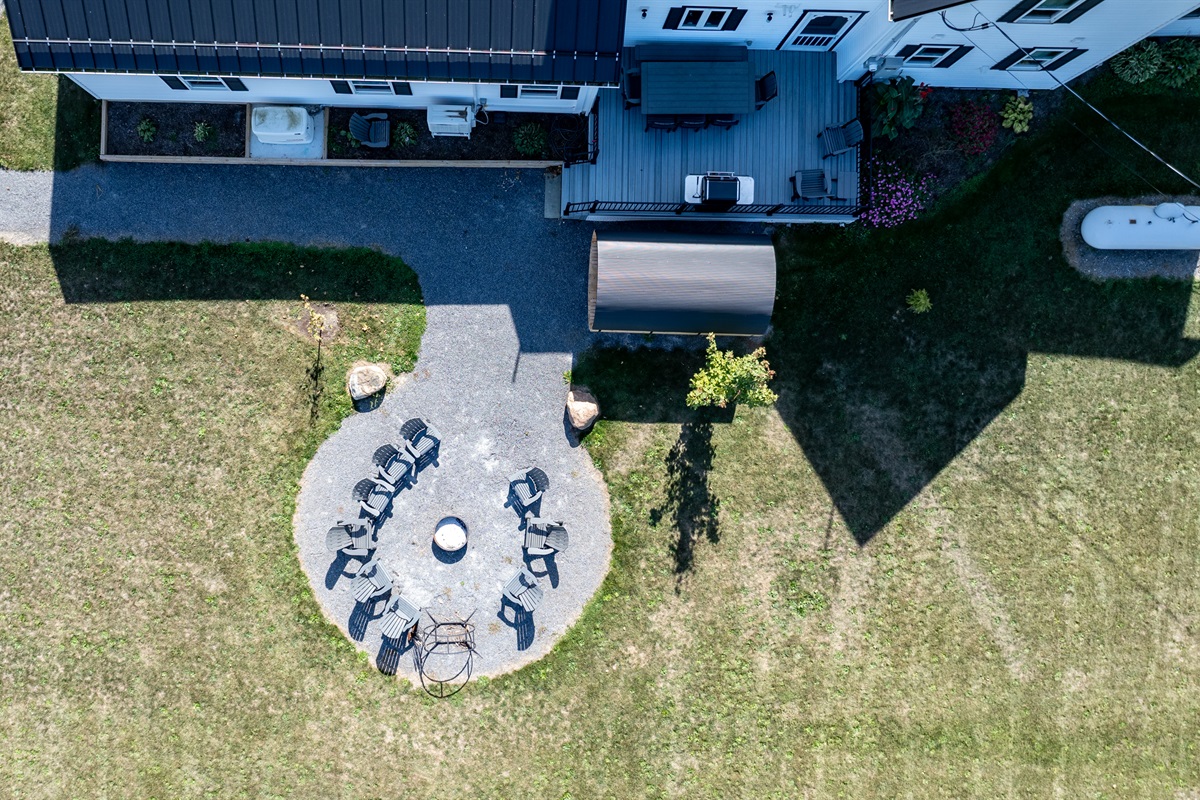 Bird’s-eye view of your private outdoor oasis — featuring a fire pit, dining area, and relaxing sauna retreat