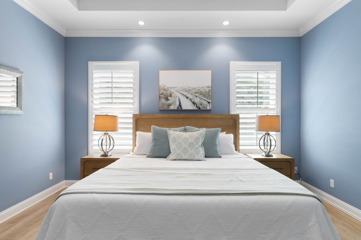 Shuttered windows flank the Primary king bed, letting you control the morning light and sleep in if you like.